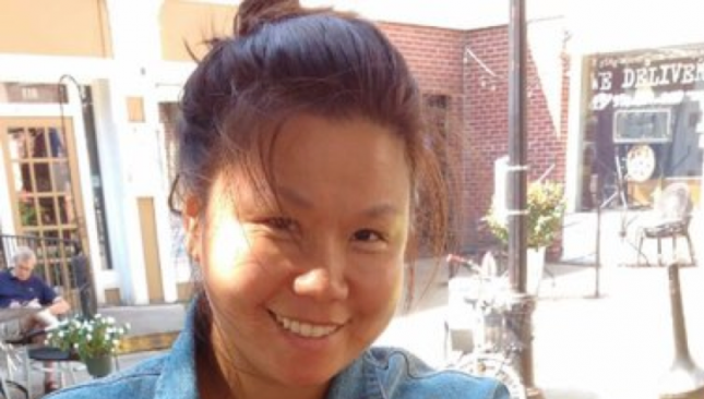 YJ Kim standing outdoors.